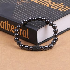 Detail of magnetic hematite beads and a micro-paved black zircon cylinder charm