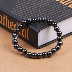 Close-up of magnetic hematite beads bracelet with a micro-paved zircon crown charm