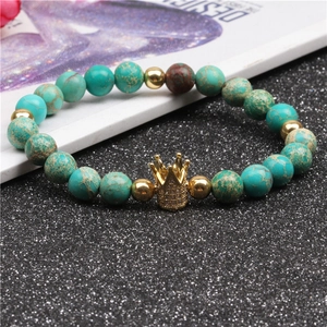 Detailed close-up of beaded crown bracelet with teal marble beads and zircon pave setting