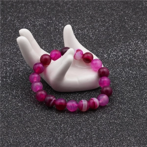 Detailed macro view of 10mm colorful agate beads with natural patterns and glass luster