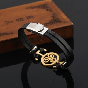 Fashionable double-layer black leather bracelet with silver clasp and golden Triskele charm
