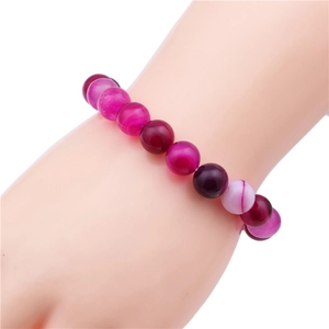 Detailed close-up of 10mm round colorful agate beads on a beaded stretch bracelet