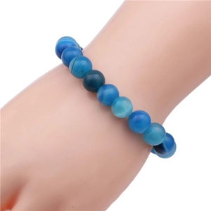 Detailed view of 10mm blue agate beaded bracelet with natural gradient stone textures