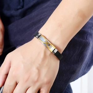 Men's fashion black silicone bracelet with a stainless steel gold infinity accent