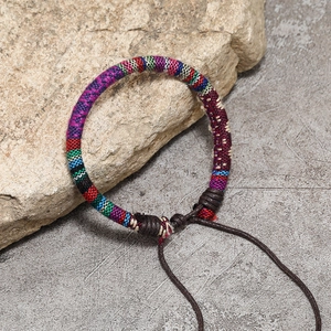 Colorful Bohemian handmade woven friendship bracelet with adjustable wax cord on natural stone