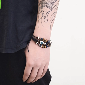 Bohemian multilayer leather bracelet with beaded charms and blue evil eye talisman charm