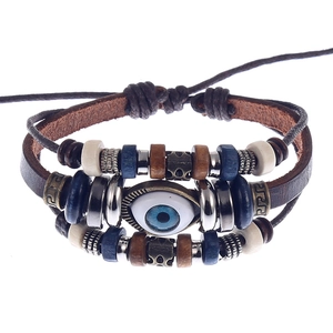 Adjustable multi-layer leather bracelet with blue evil eye bead and vintage ethnic charms