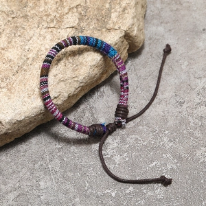 Close-up of handmade Bohemian woven cotton rope bracelet with adjustable drawstring knot