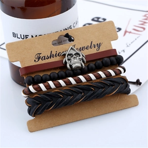 Retro punk men's leather bracelet set with skull charm and matte beads on display card
