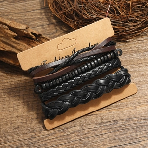 Retro mens 4-piece multilayer braided leather bracelet set with beads on wood surface