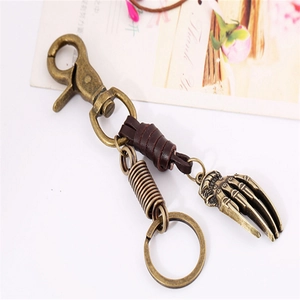 Vintage bronze alloy skeleton hand keychain with dark brown braided leather strap