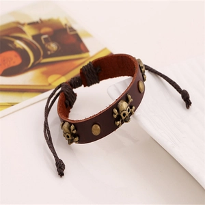Vintage brown leather skull bracelet with bronze studs and adjustable woven ropes