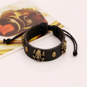 Punk black leather bracelet with bronze alloy skulls and adjustable braided cord