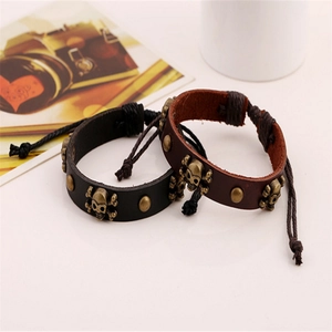 Handmade leather bracelets set with metal skull charms and wooden beads for men and women