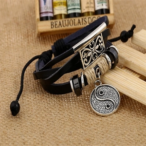 Multilayer black leather bracelet featuring a silver Tai Chi Yin Yang charm and cord