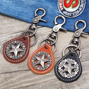 Detailed close-up of vintage leather star keychains in dark brown, caramel, and black colors