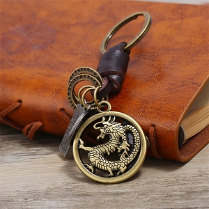 Retro handmade braided leather keychain featuring a vintage bronze dragon pendant and metal rings