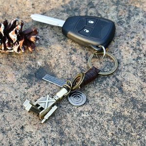 Handcrafted leather keychain with a movable alloy robot charm and vintage bronze details