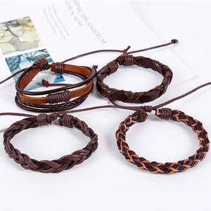 Detailed close-up of a 4-piece set of vintage braided leather bracelets with adjustable knots