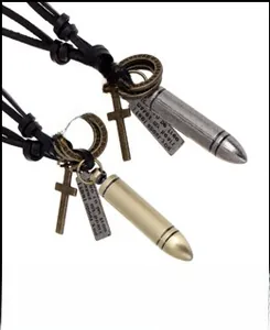 Detailed view of vintage bullet and cross pendants on black braided leather necklaces