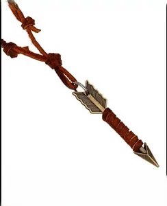 Detail of vintage bronze arrowhead pendant with brown leather cord and wrap decoration
