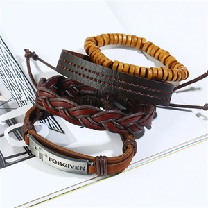 Set of four handmade vintage leather bracelets with wood beads and engraved metal plate