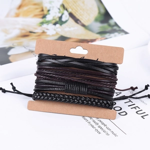Macro shot of multi-layered black and brown braided leather bracelets for men on craft card