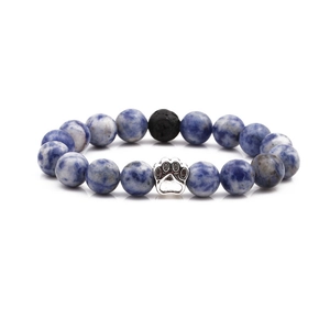 Blue sodalite stone bead bracelet with silver animal paw print charm on white background