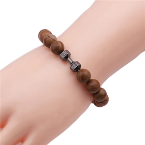 Close-up of beaded dumbbell bracelet with engraved LIVE LIFT lettering for fitness lovers