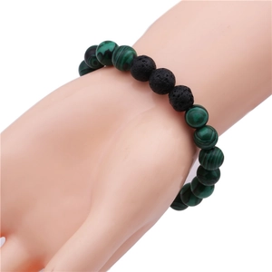 Detail of 10mm malachite and black lava rock beaded bracelet on a display hand
