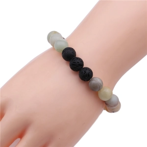 Detail of 10mm lava stone and multi-colored natural stone beads on an elastic bracelet