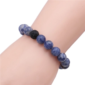 Detail shot of a 10mm dog paw bead bracelet with natural blue marble stones and lava rock