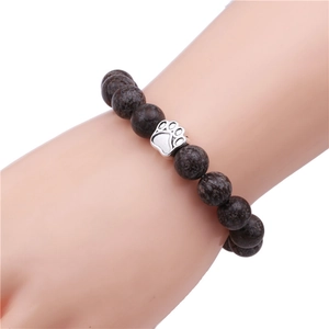 Men's 10mm dark brown beaded bracelet with a silver metal paw print charm on wrist