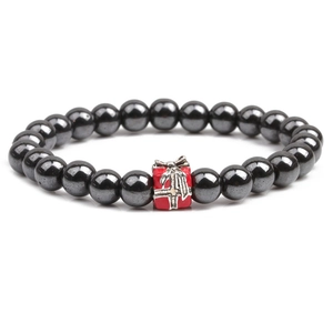 Close-up of black hematite bead bracelet with red Christmas gift box pendant detail