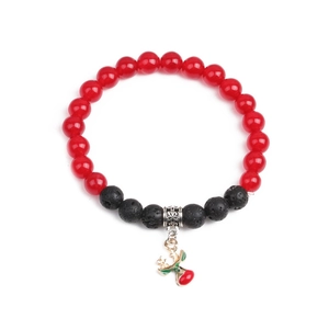 Detail of red agate and black volcanic stone Christmas bracelet with cherry charm