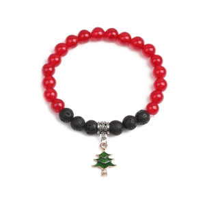 Detail of a Christmas bracelet with red agate beads, lava stones, and a green tree charm