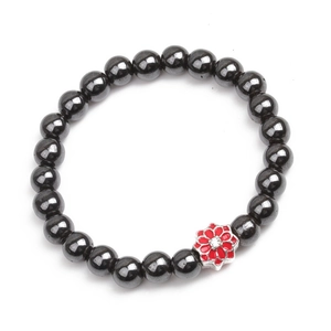Macro detail of hematite beaded bracelet with a red enamel flower and zircon stone
