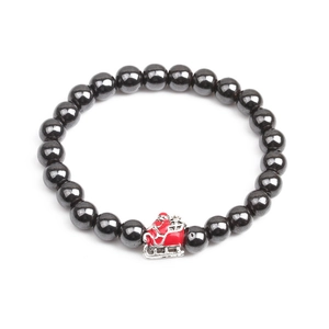 Detailed macro view of black hematite bead bracelet with red Christmas sleigh charm