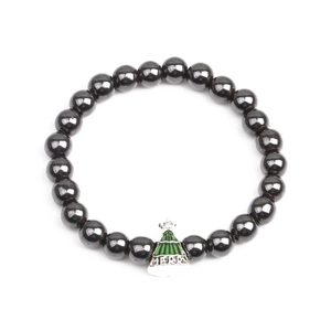 Detail of hematite beaded bracelet featuring a green Christmas tree charm with Merry text