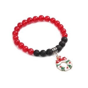 Close-up of Christmas bracelet with red agate, black lava stones and wreath charm