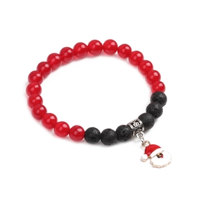 Close-up of Christmas bracelet with red agate beads, volcanic stone and Santa Claus charm