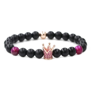Crown bracelet featuring matte black beads, purple tiger eye stones and rose gold crown charm