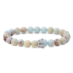 Blue natural stone beaded bracelet featuring a silver crown charm with micro-pave zircons