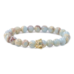 Beaded crown bracelet with blue imperial stone beads and zircon accents on a white background