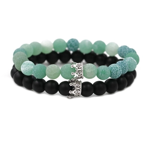 Green weathered volcanic stone and black matte bead bracelet set with silver crown charms
