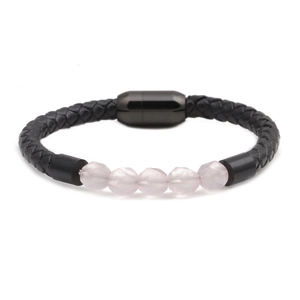 Close-up of black braided leather bracelet with pink faceted stones and magnetic clasp