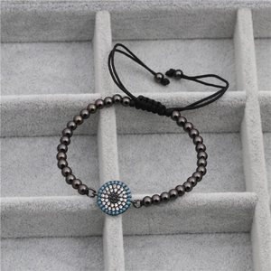 Detail of evil eye charm bracelet with micro-paved blue zircons and gunmetal beads