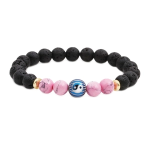 Yin Yang lava stone beaded bracelet with pink stones and golden spacers on white backdrop