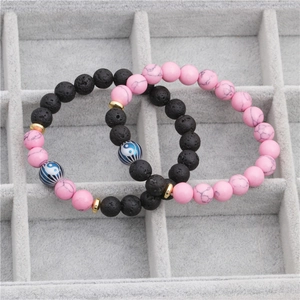 Yin Yang lava stone and pink turquoise beaded bracelets in a velvet jewelry box