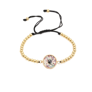 Woven gold bead bracelet with evil eye charm encrusted in colorful cubic zirconia